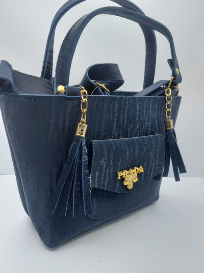 The Navy Velvet Charm Tote Bag offers a blend of luxury and functionality with its plush velvet texture, gold-tone chain accents, and versatile carrying options