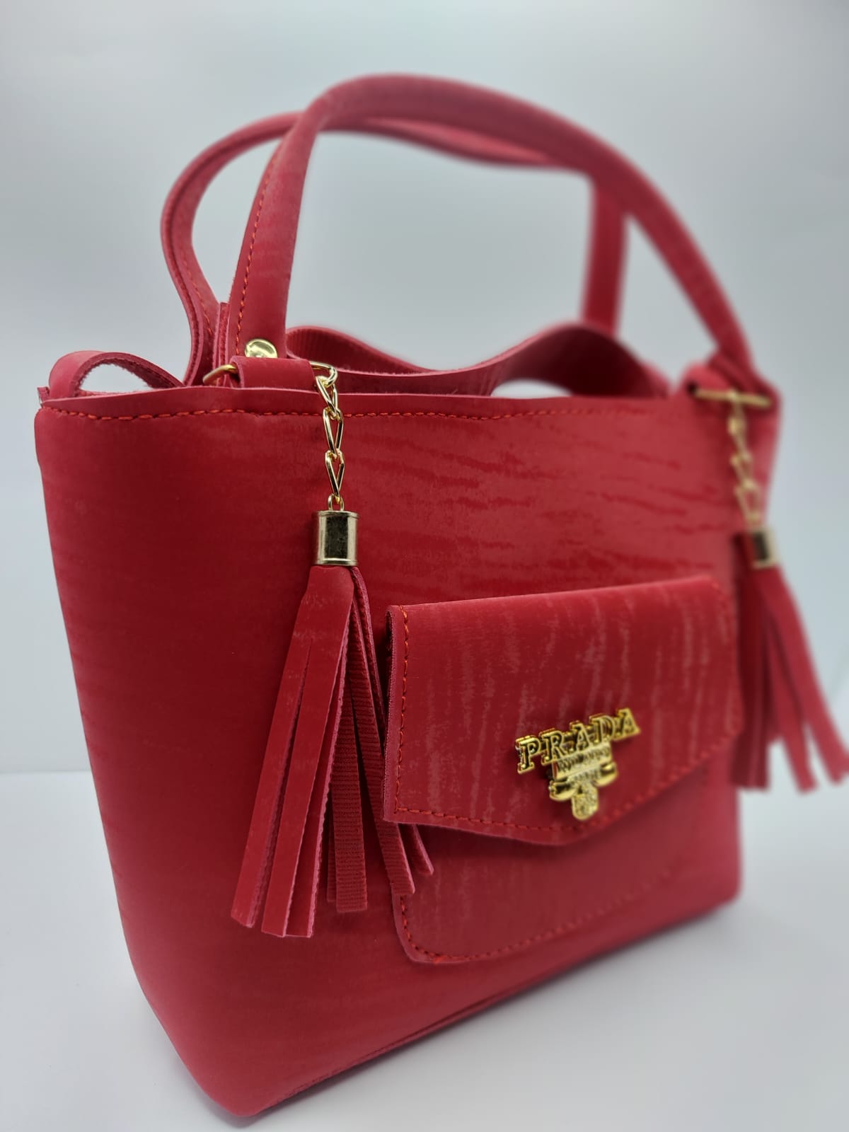 The Red Velvet Charm Tote Bag blends luxury and practicality with its plush velvet texture, gold-tone chain accents, and versatile carrying options for any occasion