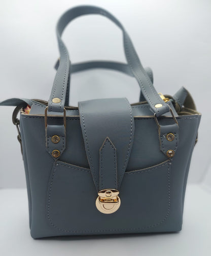 Stylish slate gray tote bag with a gold-tone lock, front pocket, and dual carrying options. Made of high-quality synthetic leather with neat stitching