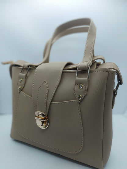 Warm Beige Regal Carry Tote Bag made of premium synthetic leather with neat stitching. Features a gold-tone lock closure, a front pocket for easy access, and an internal zippered compartment for organization. Offers dual carrying options: hand tote and adjustable shoulder strap
